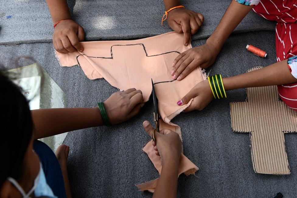 A group of people making a sanitary product