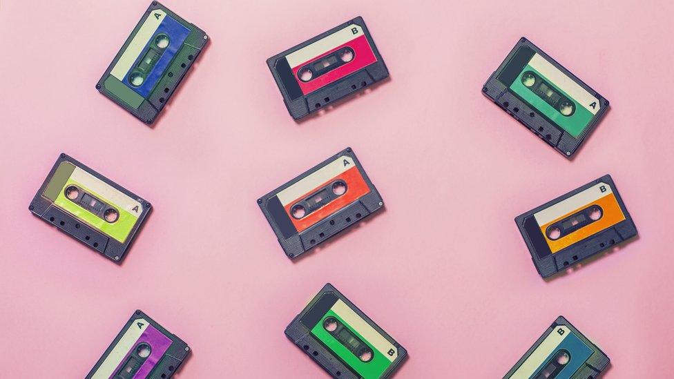 Cassette tapes on pink backdrop