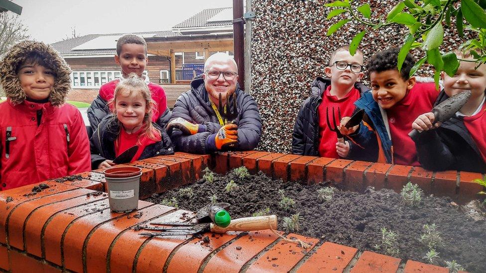 Image of Angus Walker with school children creating a Wild Space