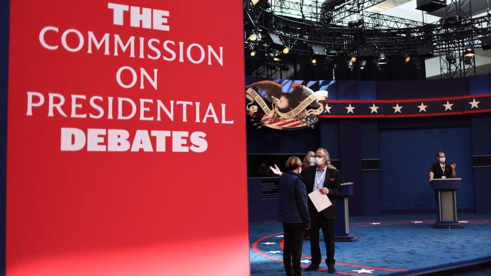 Workers prepare the stage for the first presidential debate at Case Western Reserve University