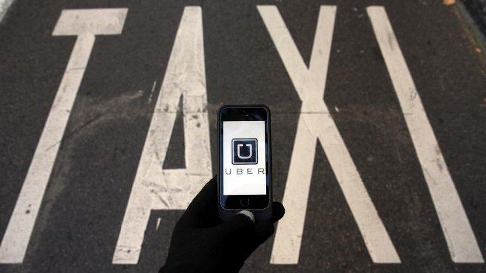 Taxi sign and Uber logo