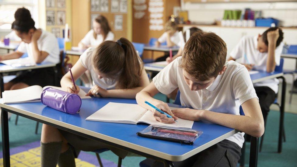 A school classroom where children are studying