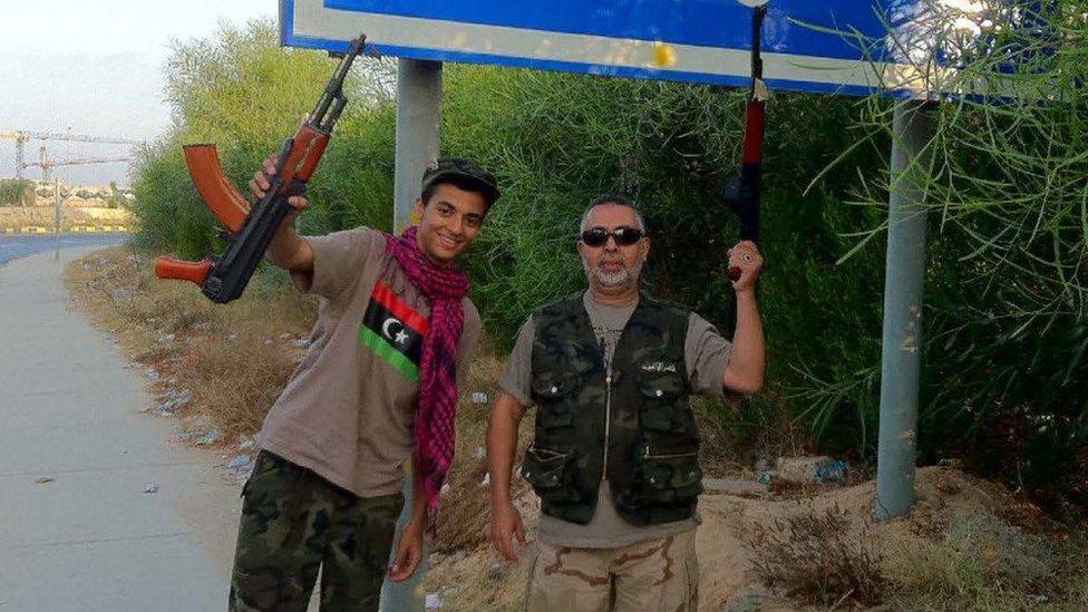 Ismail and Ramadan Abedi holding guns