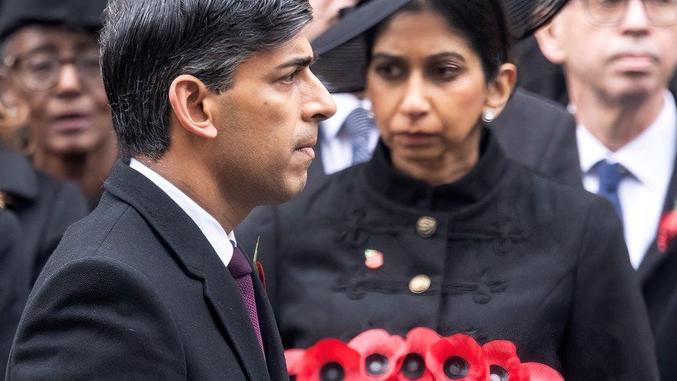 Britain's Prime Minister Rishi Sunak walks past Home Secretary Suella Braverman during the National Service of Remembrance at The Cenotaph on Whitehall in London.