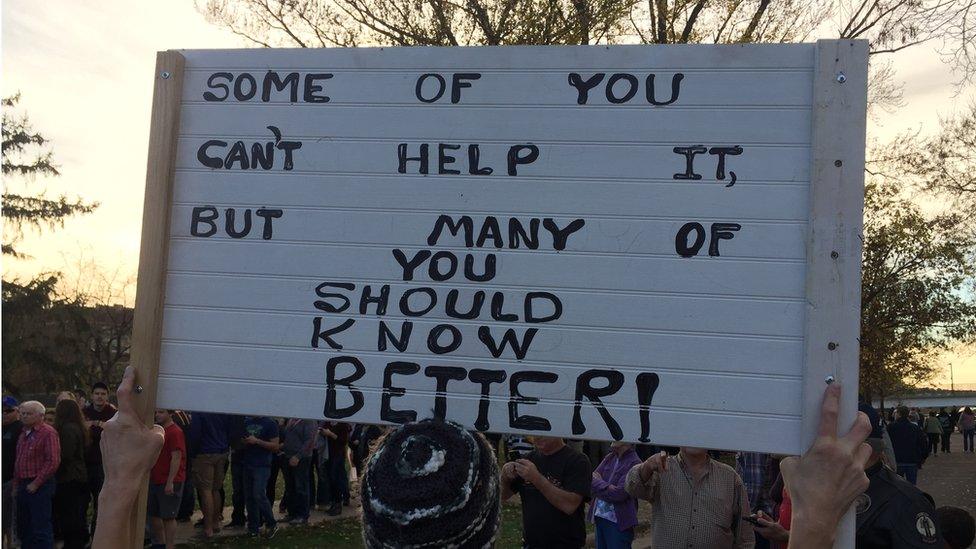 Protest sign outside Donald Trump rally