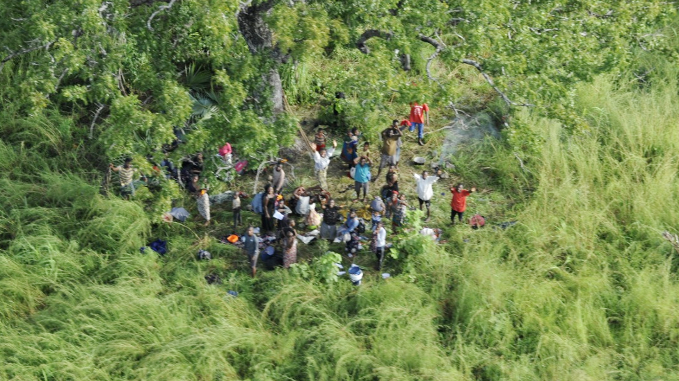 People waving at a helicopter at IVO Nhica do Rovuma near Palma, Mozambique - March 2021