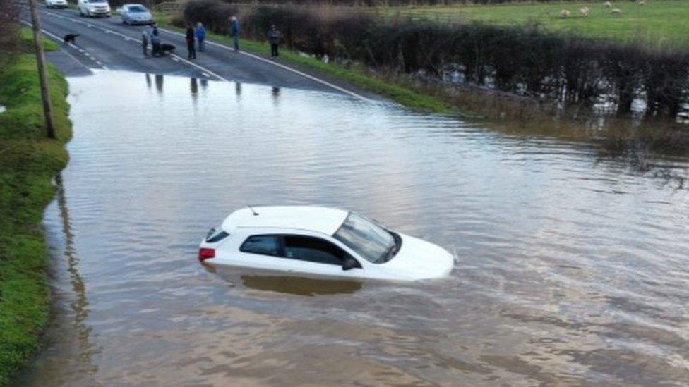 A car stuck in flood water at Dunham Bridge