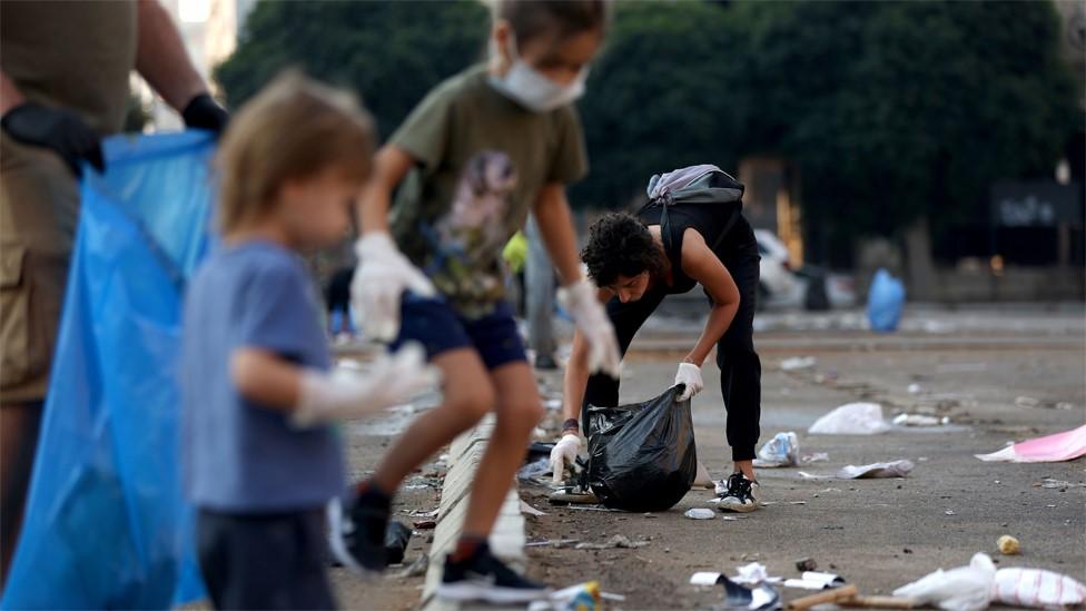 Children help clear rubbish at the site of an anti-government protest in downtown Beirut (21 October 2019)