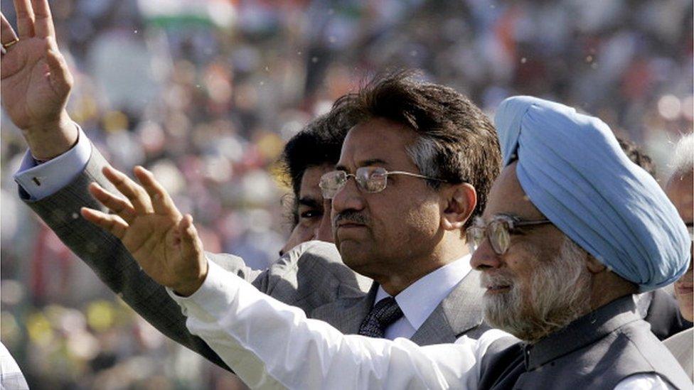 Pakistani President Pervez Musharraf (C) and Indian Prime Minister Manmohan Singh (R) salute the crowd while arriving on the pitch for the final one day international between India and Pakistan cricket teams at Feroz Shah Kotla stadium in New Delhi, 17 April 2005.