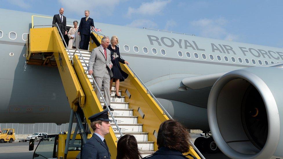 The Prince of Wales and Duchess of Cornwall leaving the plane.