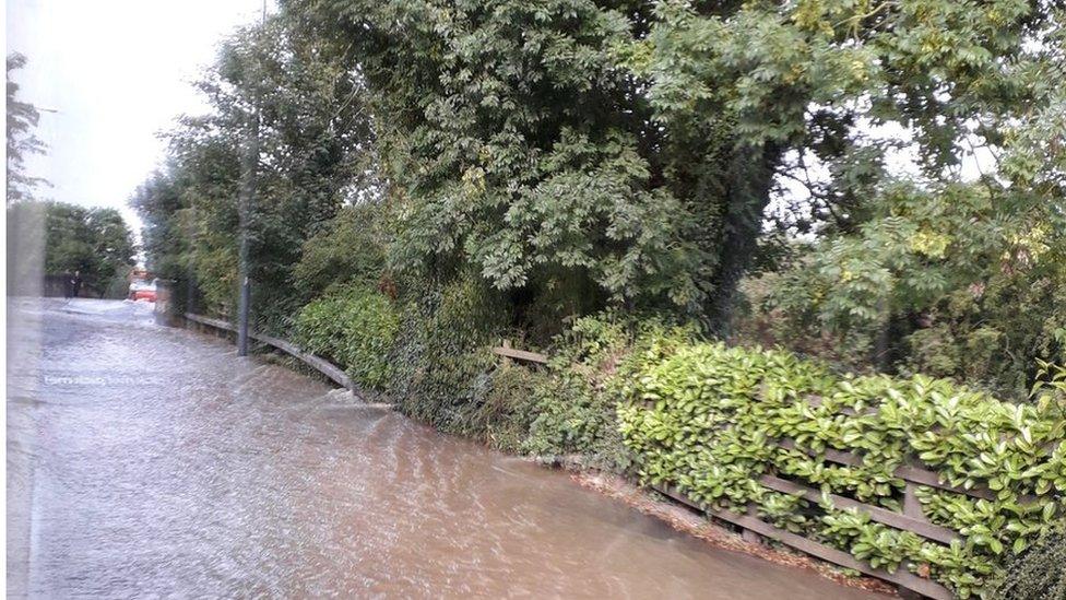 Flooded road with bus attempting to drive through