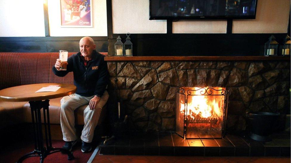 Phil Goldstraw enjoys a pint in the Hole in the Wall pub in Armagh, Northern Ireland, which reopened in September