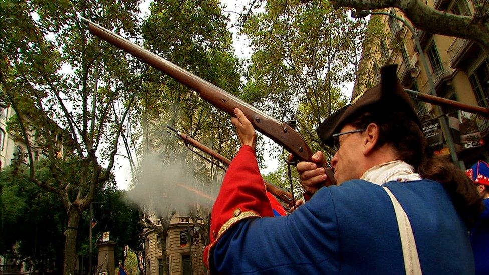 Man in historical costume fires rifle