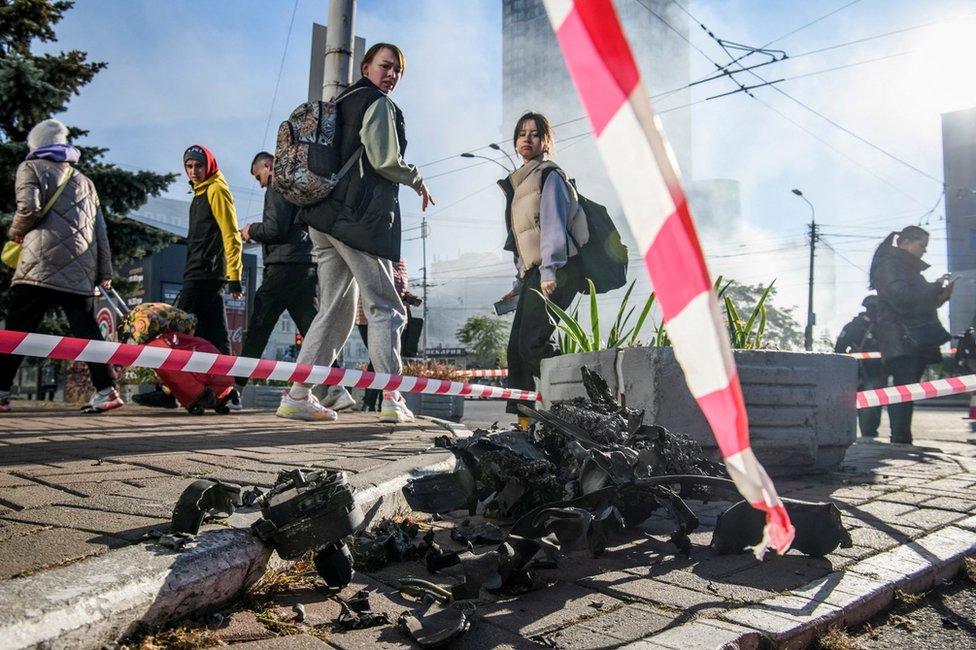 People look at the remains of an explosive drone used in a Russian attack in Kiev, Ukraine, on 17 October 2022