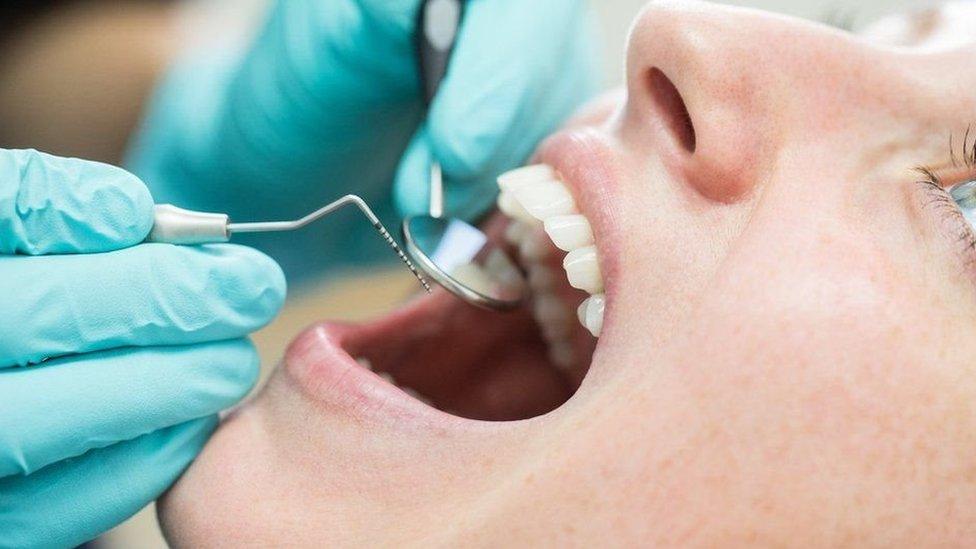 Woman having teeth checked