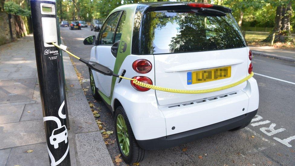 A small electric car recharging at a Source London charge point on South End Road, Hampstead, London