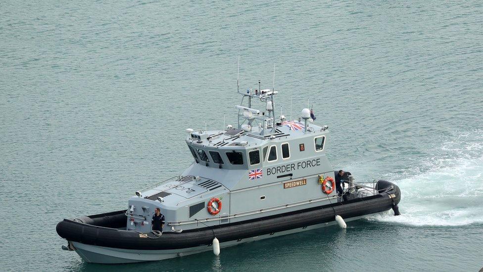 Nine men have been detained after being found in a small boat