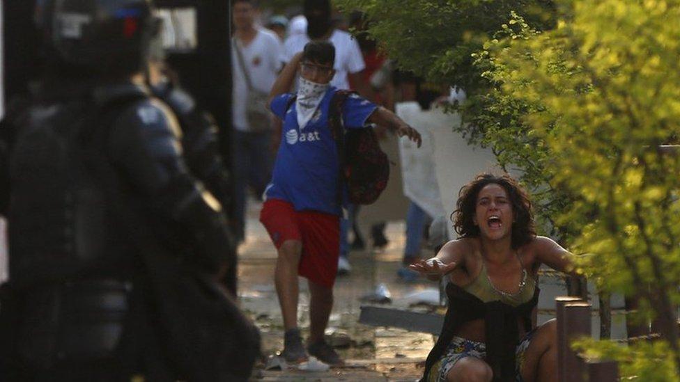 Members of the police and protesters clash in Cali