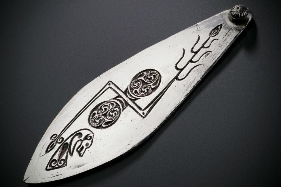 Leaf-shaped plaque of silver bearing two symbols of the early sculptured stones of Scotland Pictish from Norrie's Law Fife 7th century.jpg