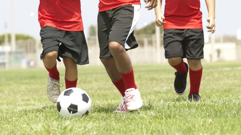 Young children playing football