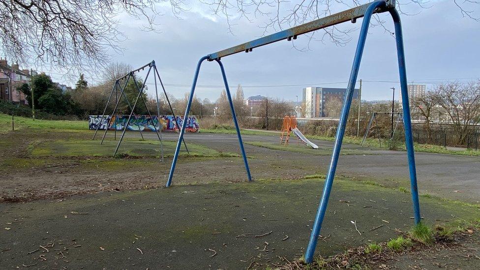 Empty swing frames in Victoria Park in Bristol