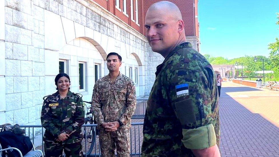 Man standing in uniform outside