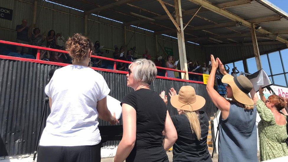 Choir leaders at the mass singalong at Twerton Park in Bath