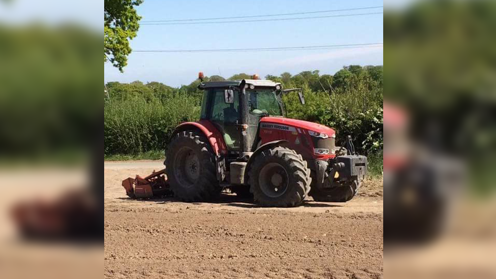 William Thomas in his tractor on his family farm