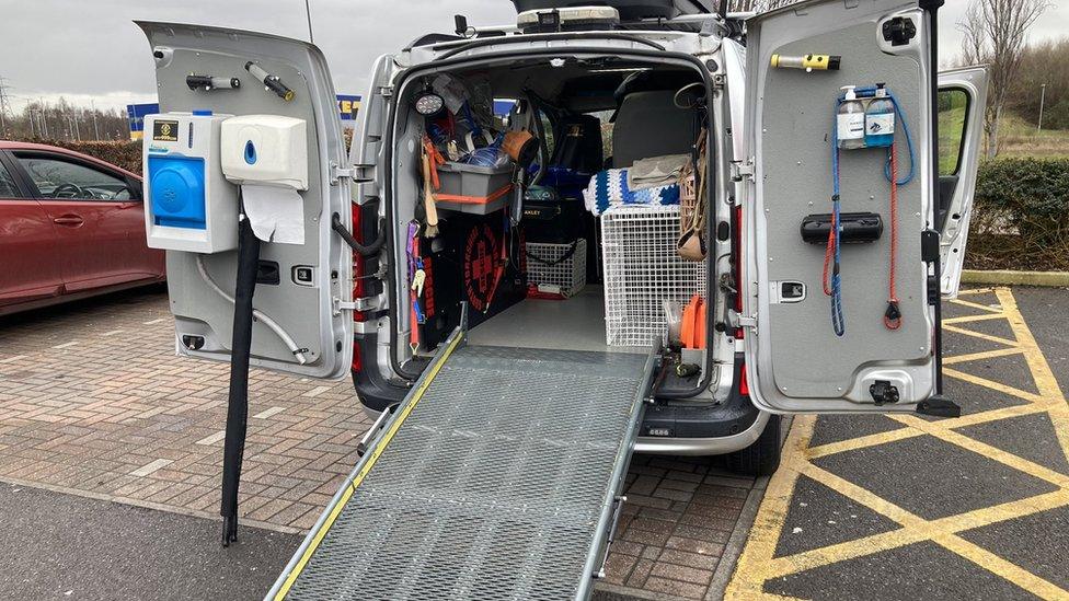 Image of an open pet ambulance stocked with medical equipment and a ramp