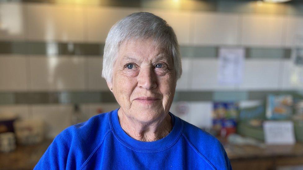 Maureen Gillet looks at the camera wearing a blue jumper