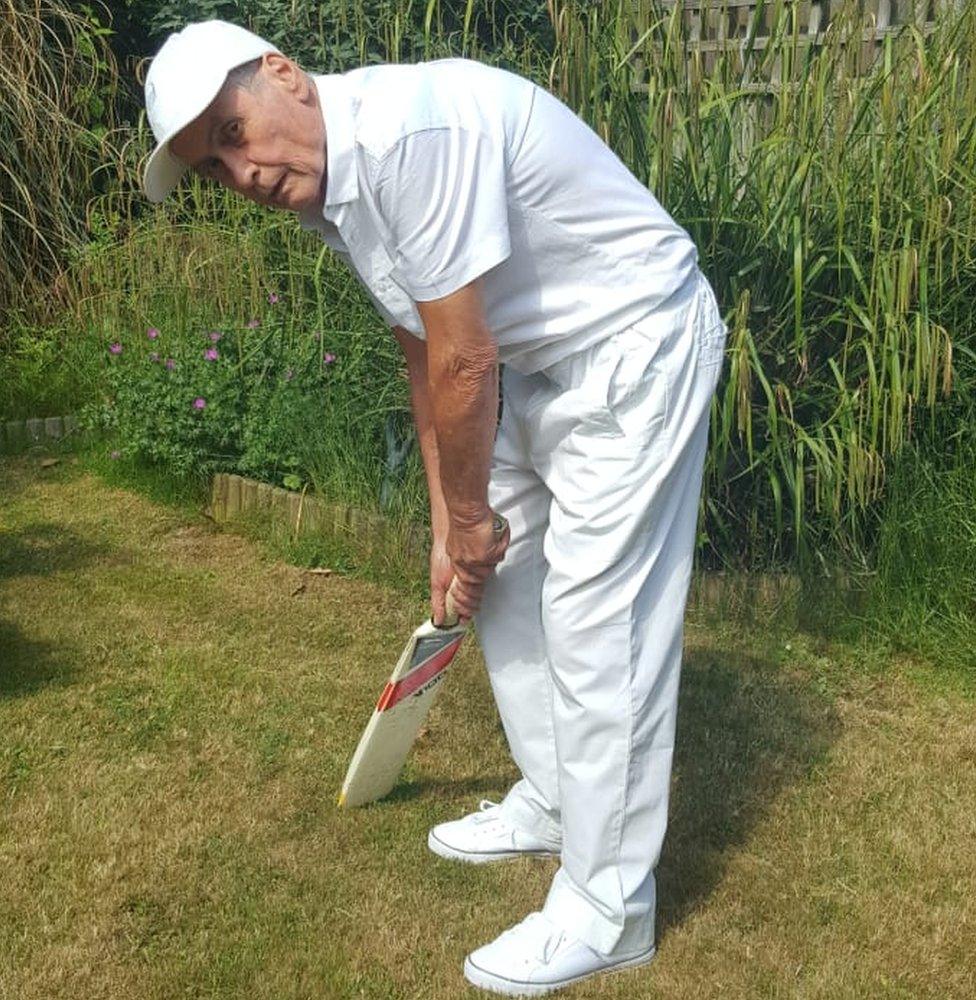 Gilbert Norman Pritchard Cann playing cricket in his garden