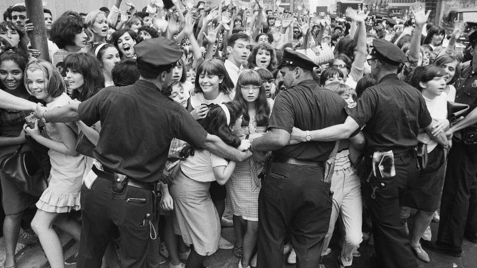 Police holding crowds of fans back