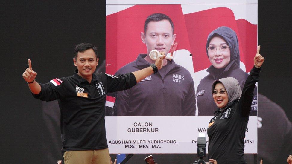 Agus Harimurti Yudhoyono (left) a candidate in the running to lead the Indonesian capital Jakarta, stands with his deputy Sylviana Murni during campaigning in Jakarta, Indonesia, February 11, 2017.