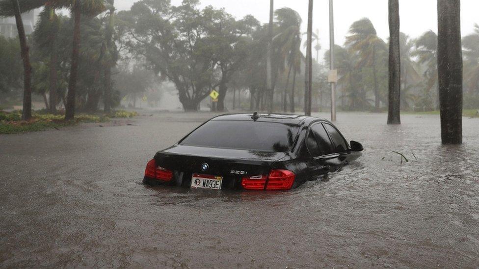 Partially submerged car in flood water