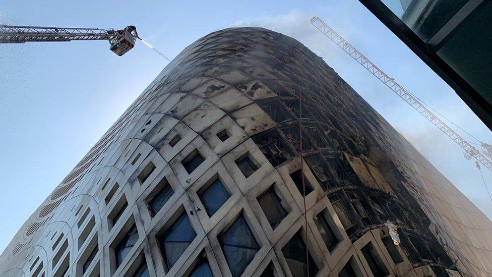 Firefighters douse the flames of a blaze that engulfed a landmark modern building, designed by the late world-renowned British-Iraqi architect Zaha Hadid, in central Beirut on September 15, 2020