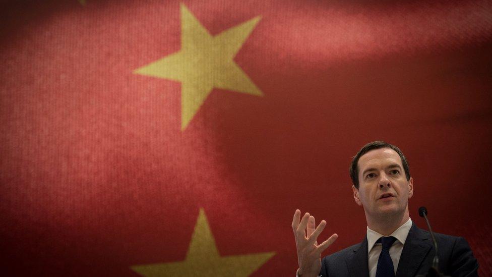 George Osborne makes a speech in front of a large Chinese flag