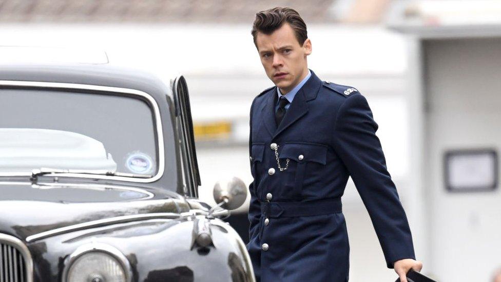 Harry Styles in police uniform.