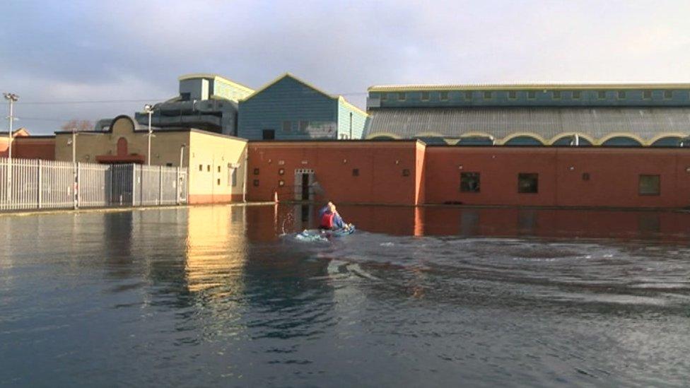 Man kayaking in an outdoor pool