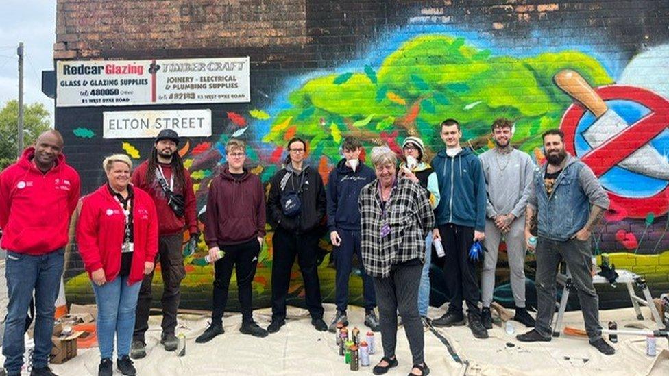 The team involved in creating the mural with Theresa Cave in centre