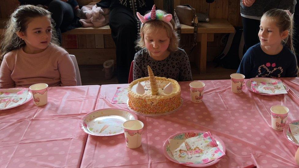 Sarah blows out the candles on her cake