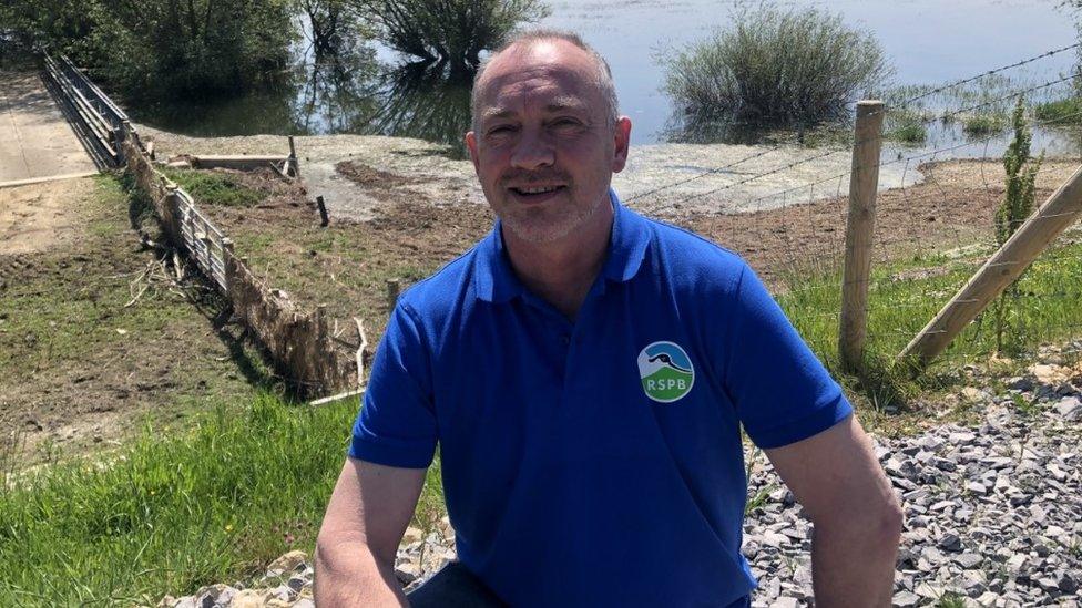 Jonathan Taylor, site manager for RSPB Ouse Washes at Welches Dam, Manea. The field behind should have cattle on, but it's flooded