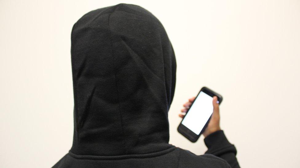 Anonymous person holding a phone