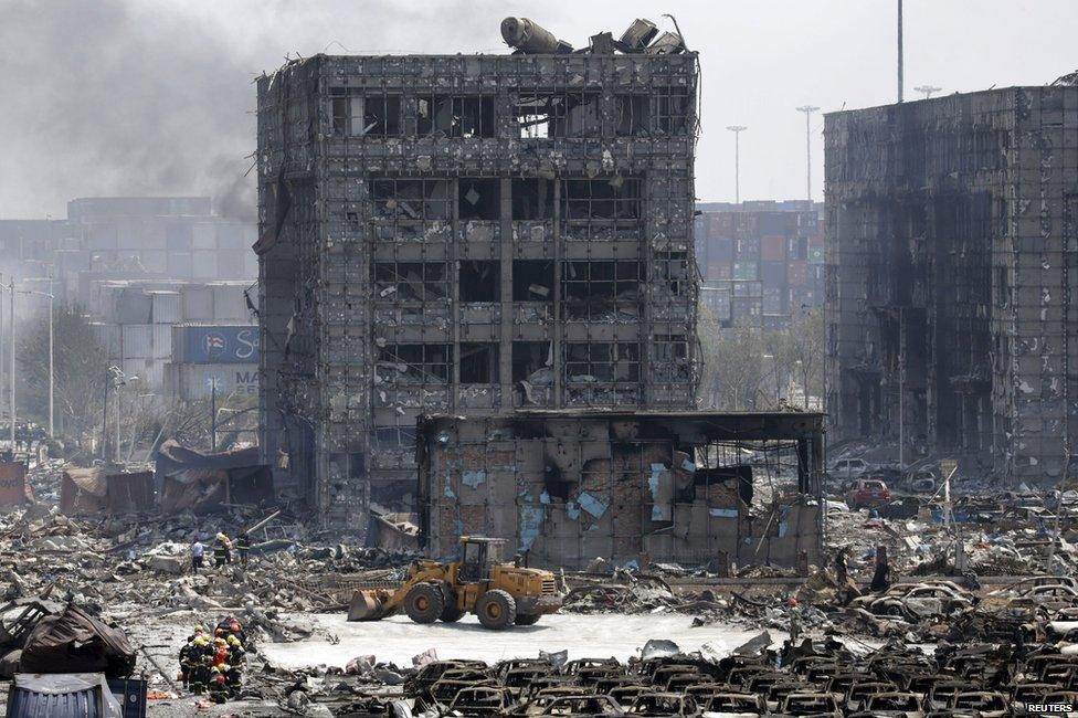 Damaged buildings and cars are seen near the site of the explosions at the Binhai new district, Tianjin, August 13, 2015.