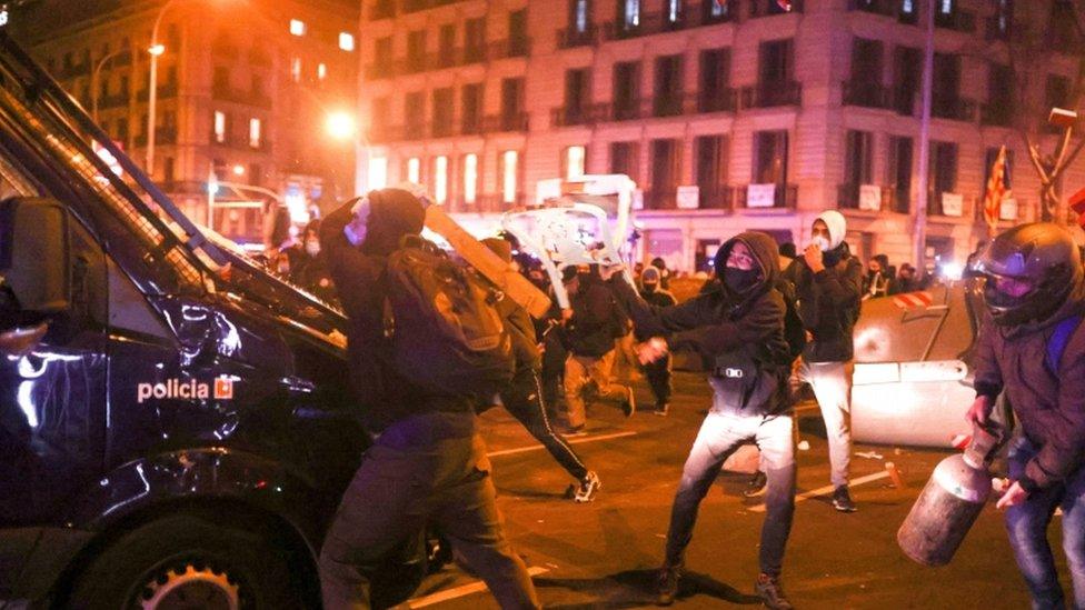 Demonstrators clash with police during a protest against the arrest of Catalan rapper Pablo Hasél in Barcelona, Spain