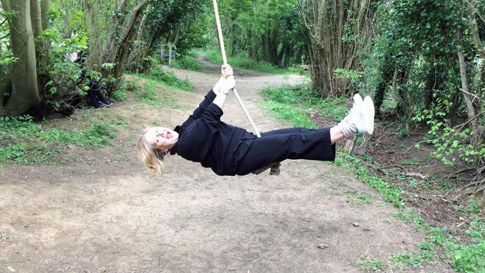 Sue on a swing in the forest