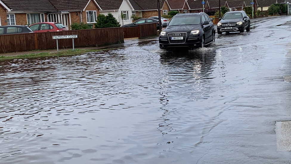 Cars navigated flooded roads in Kesgrave, Ipswich