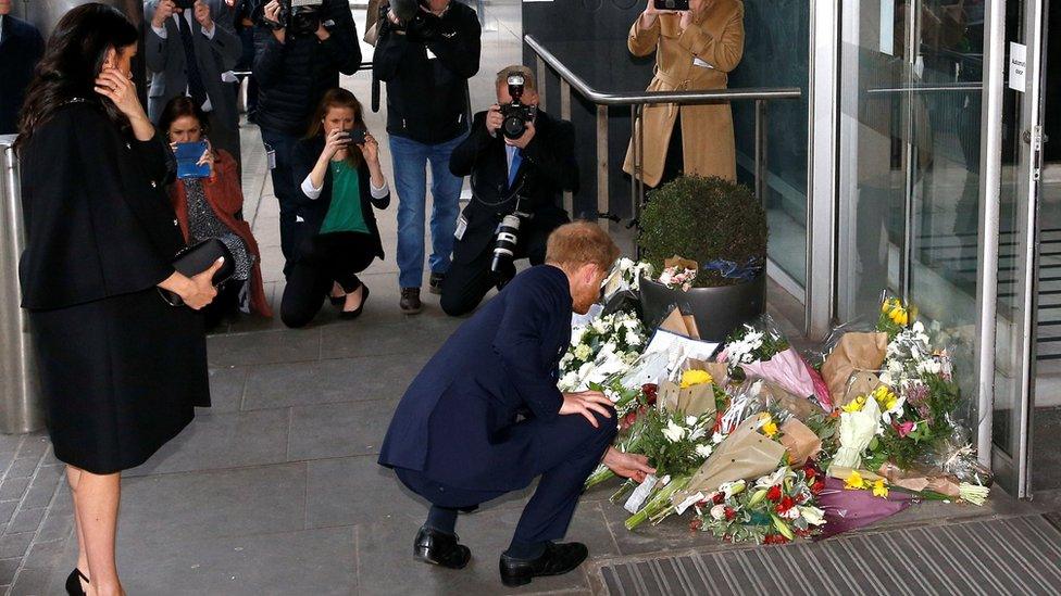 Prince Harry lays flowers outside the commission