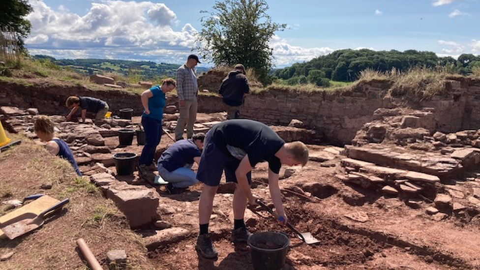 Students digging at a castle site