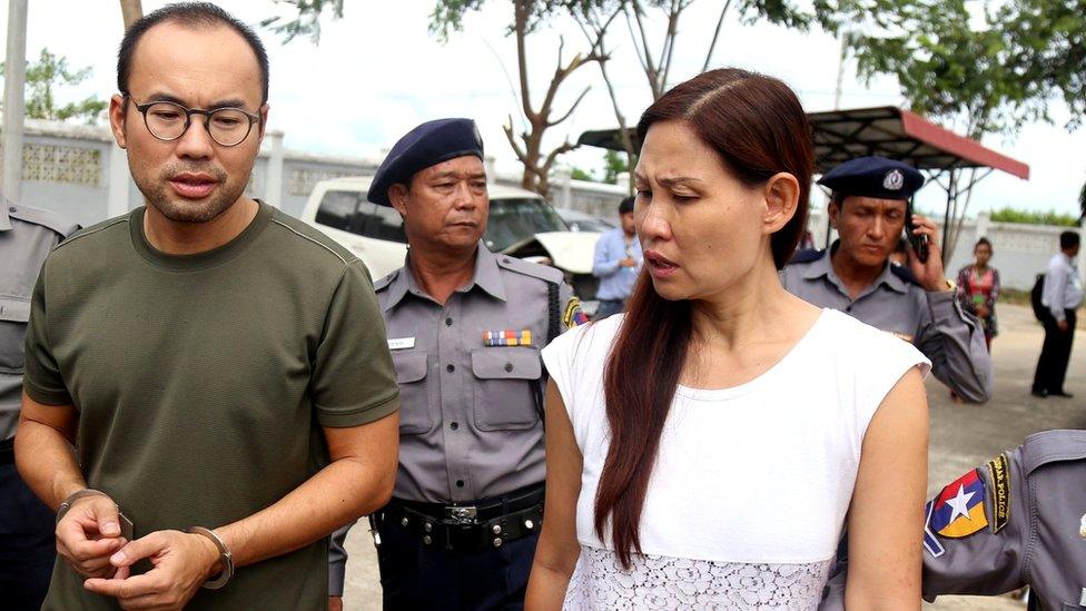 Cameraman Lau Hon Meng from Singapore (L) and reporter Mok Choy Lin from Malaysia arriving to court