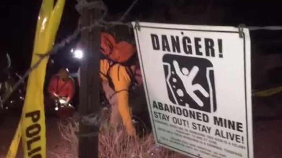 Workers prepare to descend into the mineshaft